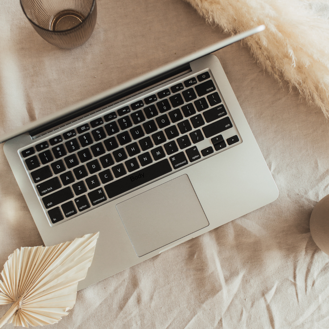 Laptop open on a bed